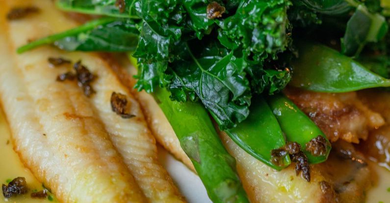 Low Prices - Roast Fish Fillets with Asparagus and Parsley Leaves on Plate