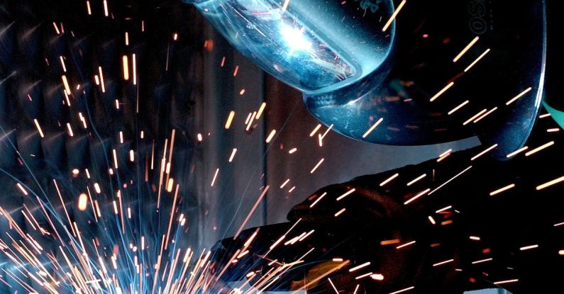 Cheap Tools - Person in Welding Mask While Welding a Metal Bar