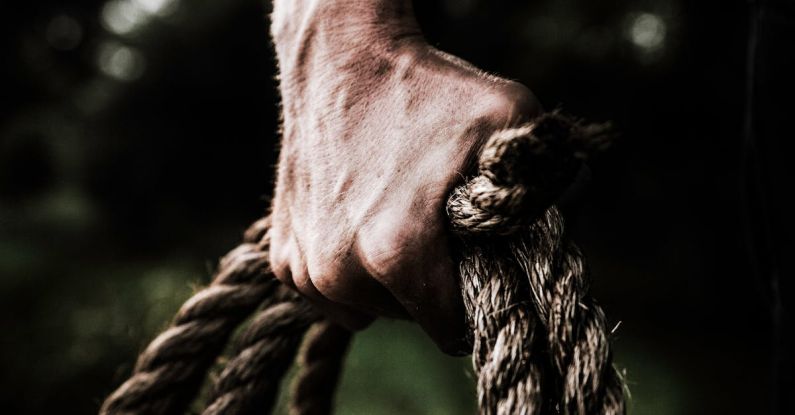 Grip - Man Holding Brown Rope