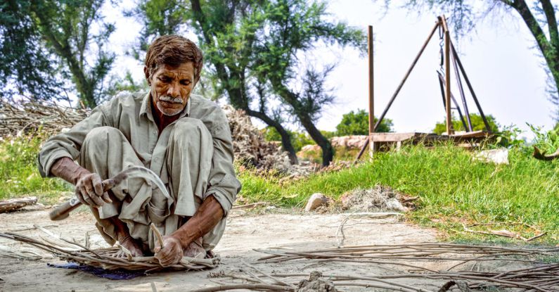Survival Skills - Elderly Man Working with Wooden Sticks