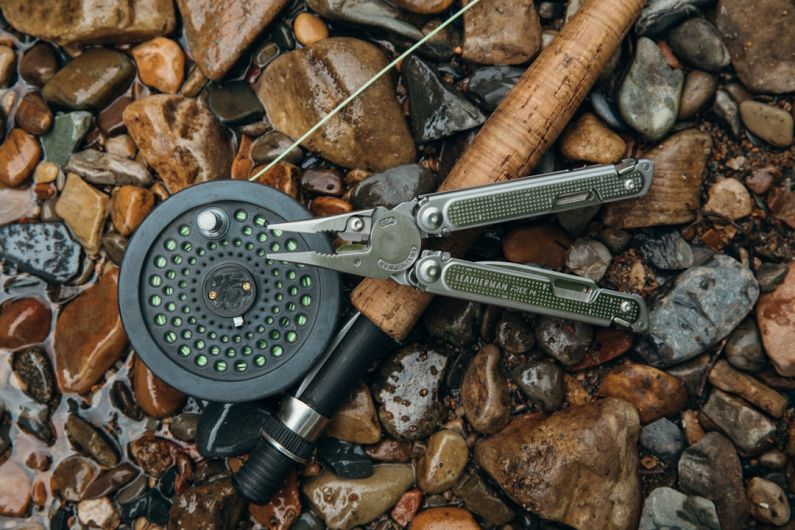 Leatherman - a pair of scissors sitting on top of a pile of rocks
