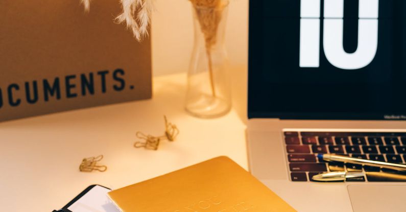 Budget Brands - Documents, Pens and Laptop on a Desk