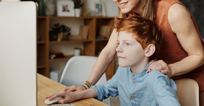 SOG MacV - Photo of Woman and Boy Looking at Imac