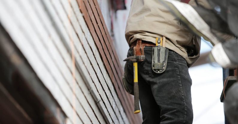 Contractors - Man Wearing Black Denim Pants With Carrying Hammer on Holster