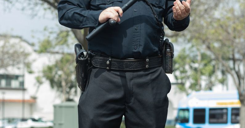SOG Baton Q4 - A Police Officer Holding a Baton