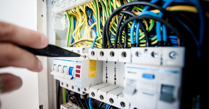 Maintenance - Electrician Fixing an Opened Switchboard