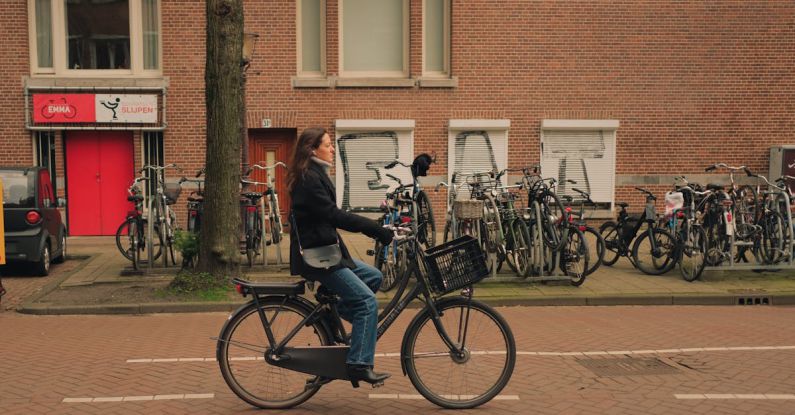 Life Hacks - A woman riding a bike down a street